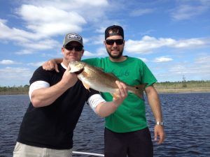 Tom Favor (left), fishing with J.J. Khoury (right), with a slot red caught using a Gulp shrimp on a shore line in the Cape Fear River.