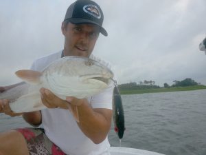 Gary Hurley with one of the many topwater reds he caught while fishing with The Redfish Guys, Dwayne Smith and Lee Padrick, in Back Sound, North River, and Core Sound.