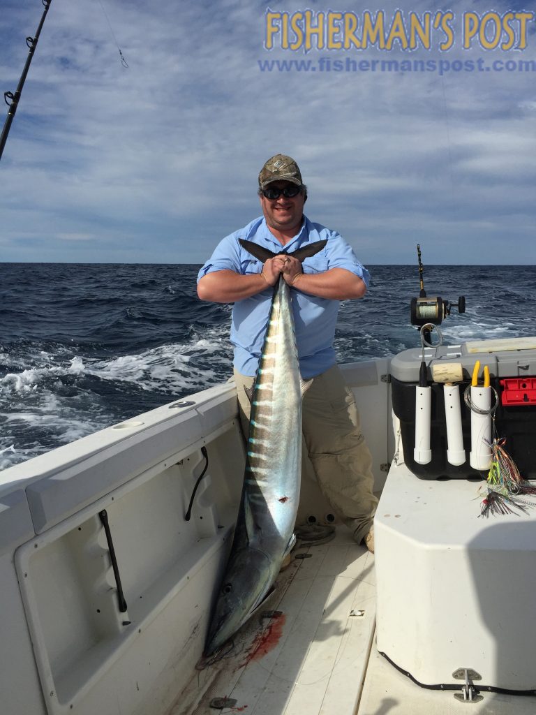 Guy Whilden with a 65 lb. wahoo that he landed after it struck a ballyhoo beneath a lure made by his fishing partner, Capt. Todd Skeen. They were trolling near the Swansboro Hole out of New River Inlet.