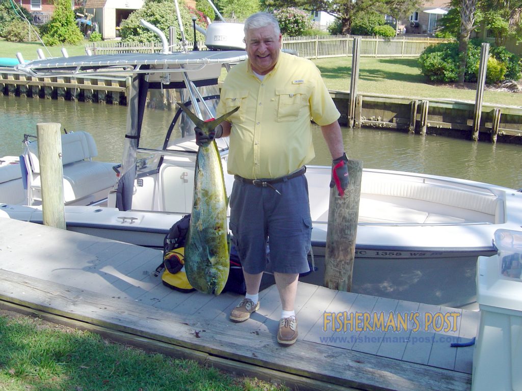 Frank Brady, of Bluefiield, VA, with a dolphin he hooked while trolling near the Big Rock.