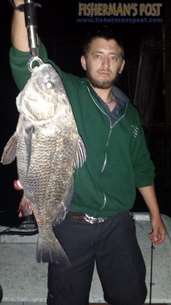 Jesse Avant, of Wilmington, with a 25" black drum he hooked on a whole shrimp while fishing Snow's Cut at night.