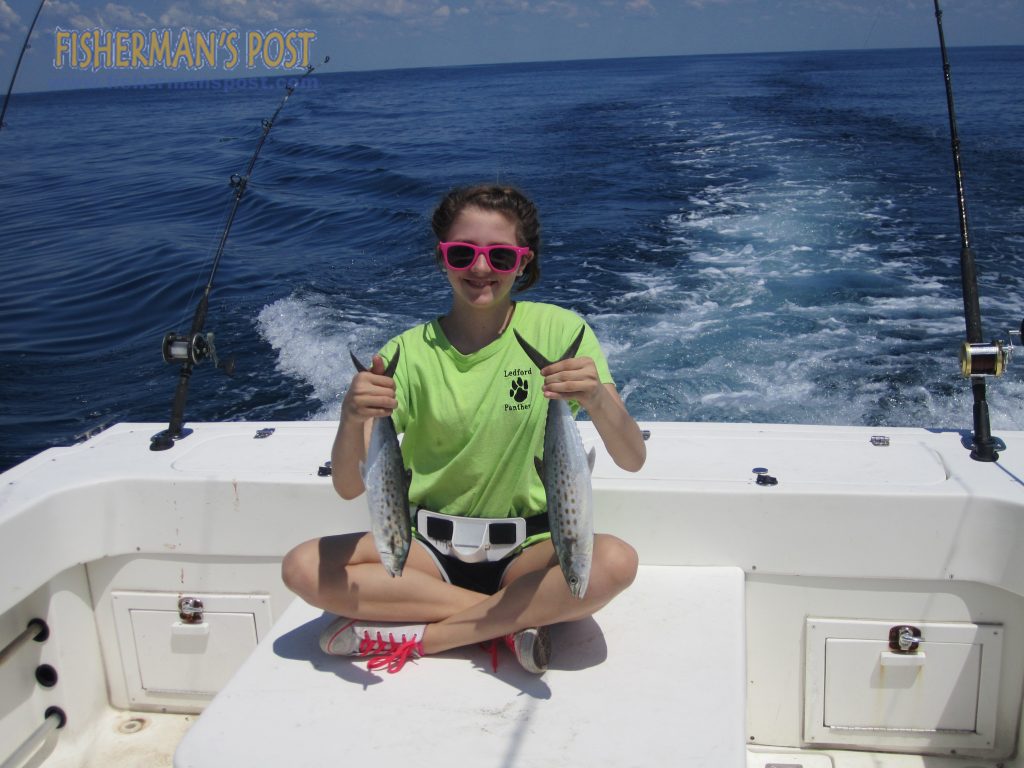 Ella McCarter, of High Point, NC, with a pair of spanish mackerel she landed on her first saltwater fishing trip while trolling aboard the "Goldfish."