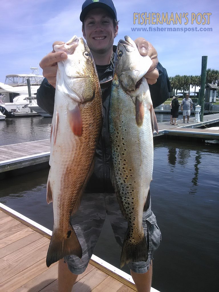 Aaron Rockwell, of Raleigh, NC, with a 25" red drum and a 25" speckled trout that bit live baits near Oak Island while he was fishing with Capt. Greer Hughes of Cool Runnings Charters.