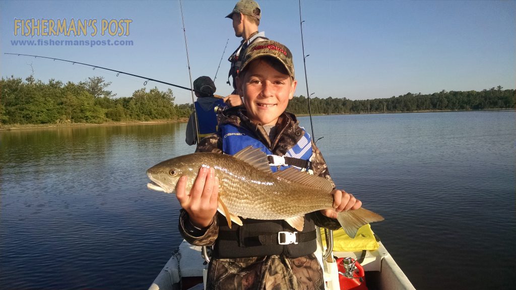 Eli Young, of Burgaw, NC, with a 24" red drum that he hooked while sight-casting a Z-Man shrimp in Stones Bay near Sneads Ferry.