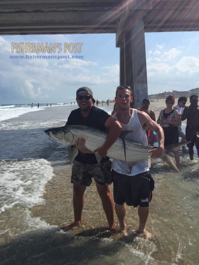 Harrison Hall and Jacob Thompson prepare to release an estimated 75 lb. tarpon Thompson battled after it struck a live bluefish off the end of Johnnie Mercer's Pier.