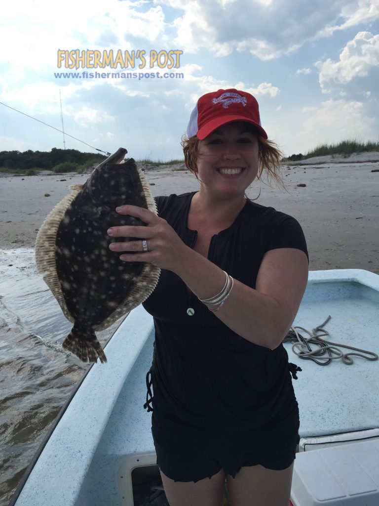 Joy Balderson, of Wilmington, with a keeper flounder that bit a live bait while she was fishing in Carolina Beach Inlet.