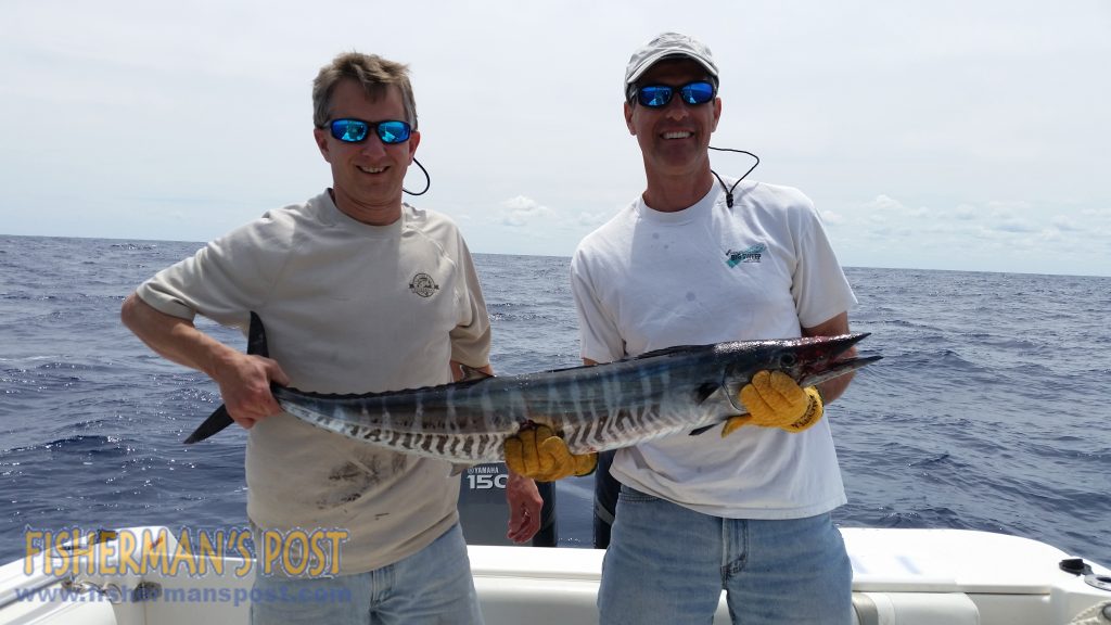 Braxton Davis and Mike Lopanski, of Morehead City, with a wahoo they hooked while trolling skirted ballyhoo at the Big Rock.