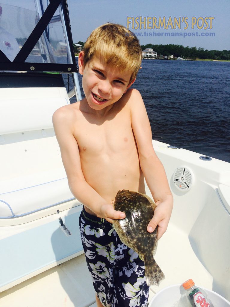 Brayden Fisher with his first flounder, hooked on a live mullet just outside Inlet Watch Marina.