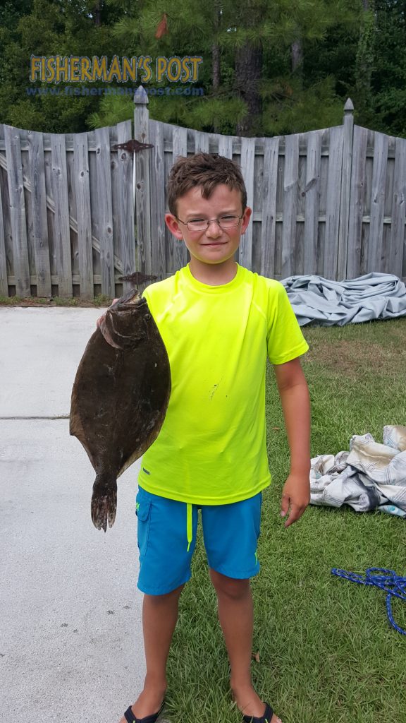 Parker Smith with a 20" flounder that struck a live finger mullet while he was fishing in Carolina Beach Inlet with his father.