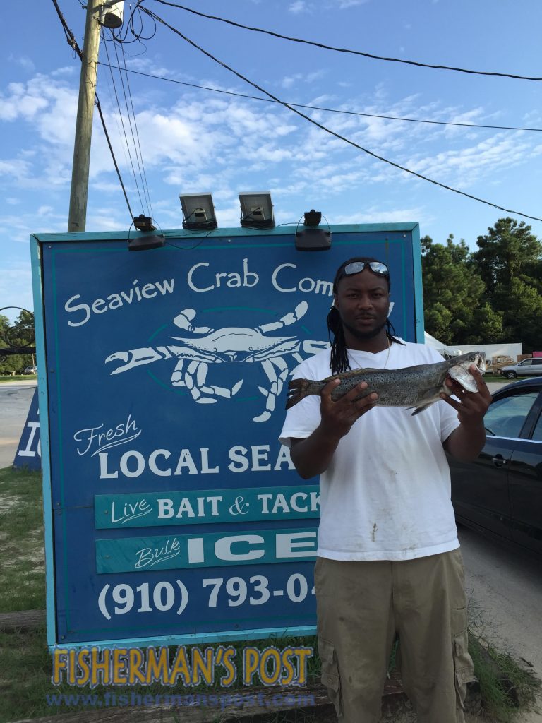 Jeffrey Garris with a 25" speckled trout he hooked on a live finger mullet while fishing in Snows Cut. Photo courtesy of Seaview Crab Co.