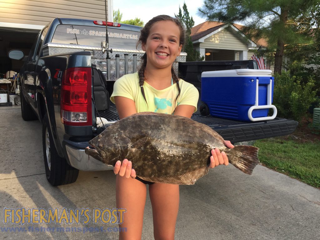 Mattie Phillips with a 3 lb. flounder she hooked while drift-fishing a live finger mullet with her father, Capt. Brad Phillips, on the "Fish Spanker."