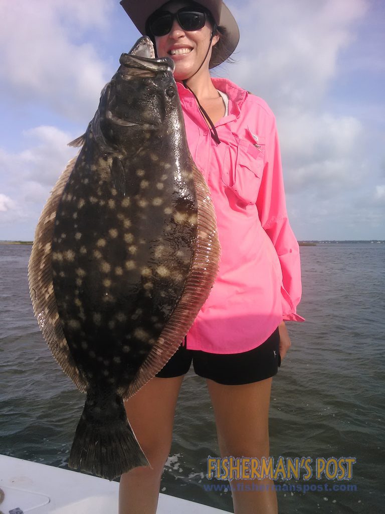 Ryan Wilson, of Raleigh, with a large flounder that struck a live bait near Bald Head Island while she was fishing with Capt. Greer Hughes of Cool Runnings Charters.