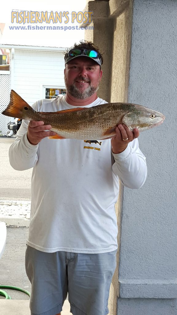 Jason Long, of Wilmington, NC, with a 27" red drum he landed on a Carolina-rigged mullet while fishing near Bald Head Island.