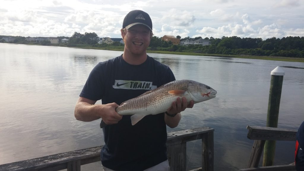 Ben Shifflett, of Winston-Salem, NC, with a 6 lb. red drum he hooked off an Oak Island dock.