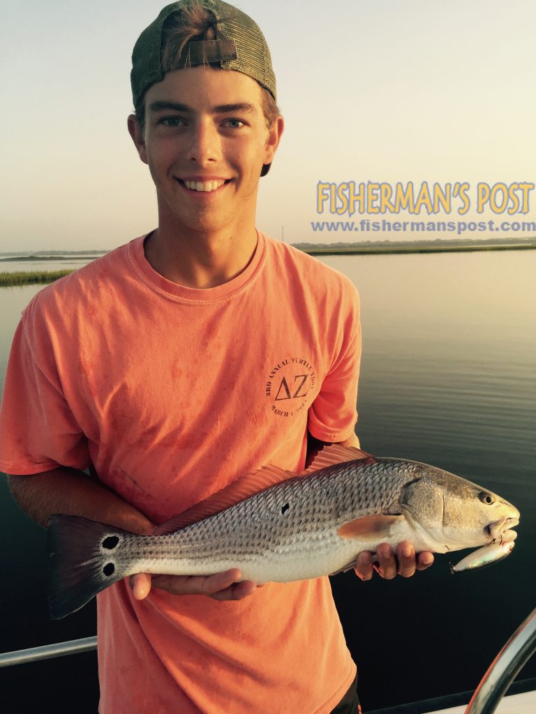 John Robert King, of Wilmington, with a slot red drum that bit a topwater plug in an Emerald Isle marsh while he was fishing with John Mark Lavigne.