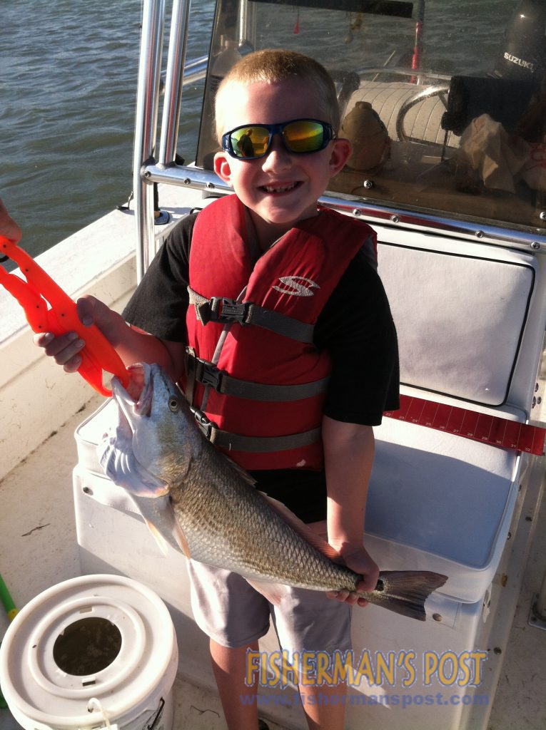 Connor McLean (age 7) with his largest red drum, a 25" fish that struck a live menhaden in the ICW near Topsail Island.