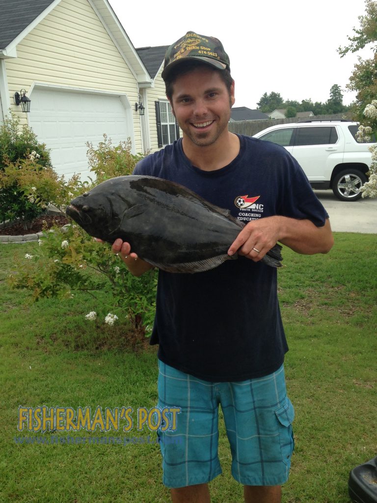 Matt Uckert with a 22.5" flounder he hooked in a Hampstead creek off the ICW after it struck a live finger mullet.