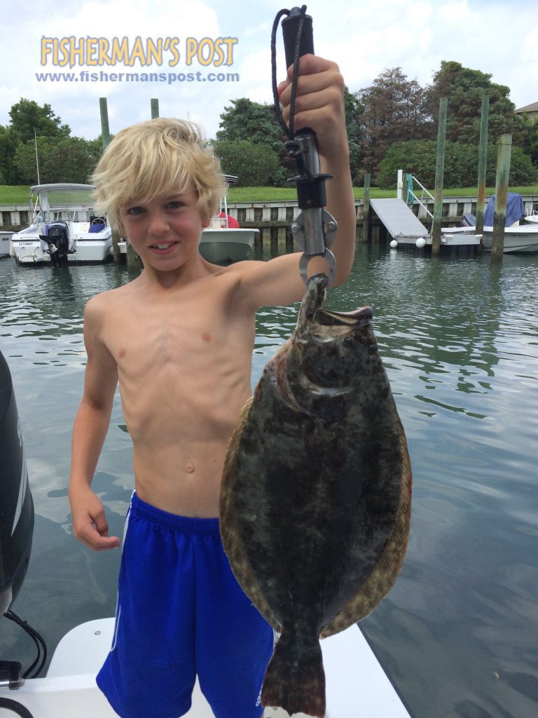 Sean Benson (age 9), of Hampstead, NC, with a 3.3 lb. flounder he hooked while fishing Motts Channel at Wrightsville Beach.