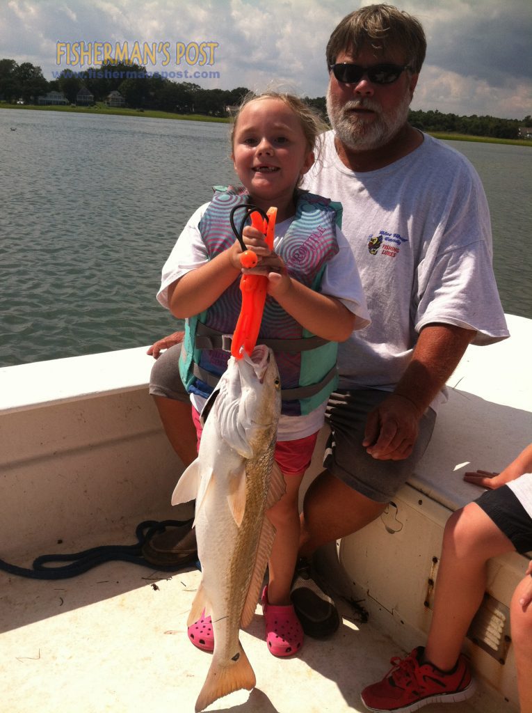 Taylor McLean (age 5) and her grandfather, Capt. Jodie Gay of Blue Water Candy Lures, with a 29.5" red drum she landed while fishing the ICW near Topsail Beach with her brother Connor and stepfather Russell Weaver.