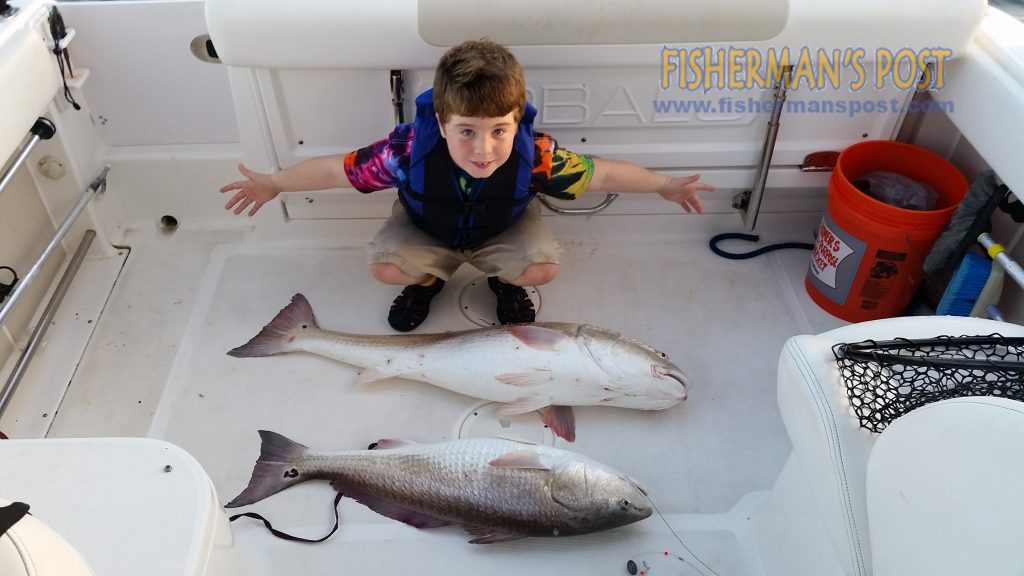 Gabe Keith, of Southport, NC, with a pair of red drum he and his father Randall caught and released at the same time while fishing live baits near AR-425.